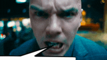 a close up of a man 's face with his mouth open