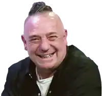 a man with a mohawk on his head is smiling and wearing a black shirt