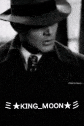 a black and white photo of a man in a hat and tie with the words king moon written below him