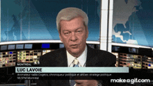 a man in a suit and tie with the name luc lavoie on the bottom right