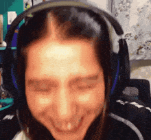 a woman wearing headphones is making a funny face