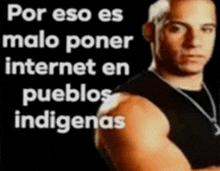 a man in a black tank top is standing in front of a black background .