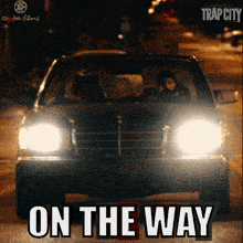 a poster for trap city shows a car driving down the street