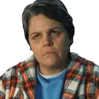 a woman wearing a plaid robe and a blue shirt is looking at the camera