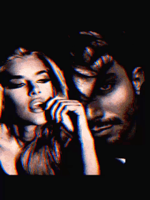 a man and a woman are looking at each other