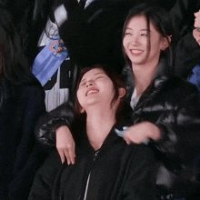 a group of girls are posing for a picture and one of them is laughing