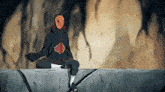 a person with a mask on their face is sitting on a ledge