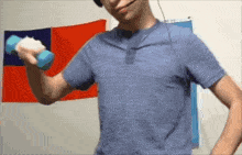 a man in a blue shirt holds a blue dumbbell