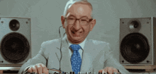 an older man in a suit and tie is playing music