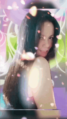 a woman with long hair is surrounded by petals on a purple background