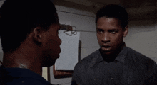 two men are standing next to each other and one has sweat on his face