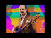 a man with a mustache is holding a guitar in front of a rainbow background
