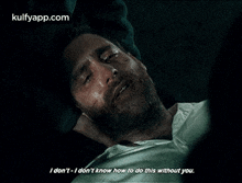 a man with a beard is laying on the ground with his eyes closed and a quote from a movie .