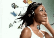 a woman wearing beats headphones is smiling