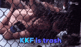 a ufc fighter is laying on the ground in a cage with the words kkf is trash below him