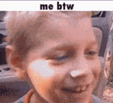a close up of a child 's face with the words `` me btw '' written on it .