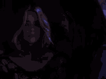 a couple of women hugging each other in the dark