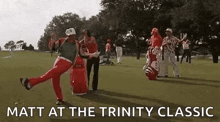 a group of people are playing golf on a golf course and one of them is standing on one leg .