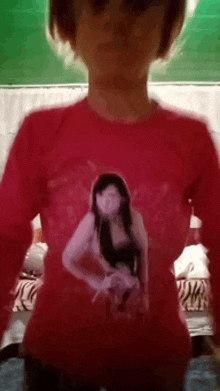 a girl in a red shirt with a picture of a woman on it
