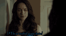 a woman in a blue dress looks at another woman