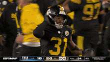 a football player with the number 31 on his jersey stands on the field