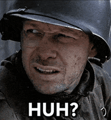 a man wearing a helmet with the words huh written on his face