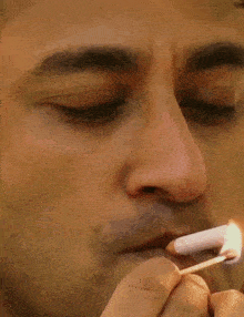 a man lighting a match in his mouth