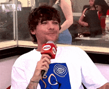 a man in a white shirt is holding a microphone with the word mix on it