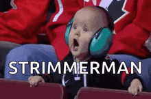 a baby wearing ear muffs is sitting in a stadium watching a hockey game and the words strimmerman are displayed