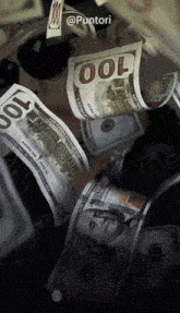 a pile of 100 dollar bills falling from the sky