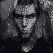 a black and white painting of a man 's face with a lace veil covering it .
