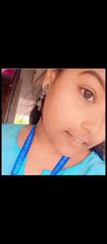 a close up of a woman 's face with a blue lanyard around her neck that says ' pharmacy ' on it