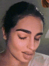 a close up of a woman 's face with her eyes closed and her mouth open