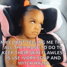 a little girl is sitting in a car seat with a funny face .