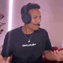 a man wearing headphones and a shirt that says eviliah