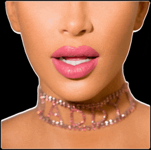 a close up of a woman wearing a choker that says daddy