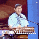a man speaking into a microphone with the words cardinal written on the bottom