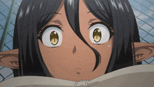 a close up of a girl 's face with a chain link fence behind her