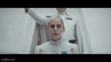 a man and a woman are standing next to each other in a room .