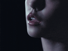 a close up of a woman 's face with her mouth open