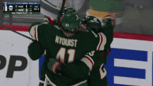 a hockey player with nyquist on his jersey hugging his teammates