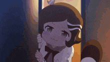 a little girl with a bow on her neck is standing in a doorway