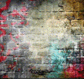 a colorful brick wall with a few spots of paint on it