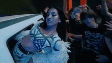 a woman in a crop top is surrounded by people wearing shirts that say episode