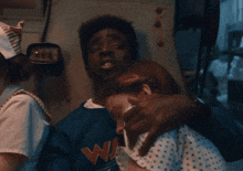 a man wearing a g-shock watch is hugging another man