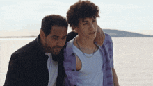a man and a boy are standing next to each other