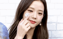 a woman has a sticker on her face that says ' bunny ' on it