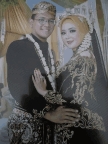 a bride and groom pose for a picture with the bride wearing a black dress