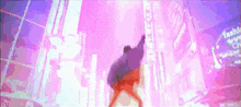 a person is dancing in front of a sign that says ' fashion ' on it