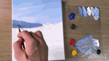 a person is painting on a canvas and the words made in animatica are on the bottom